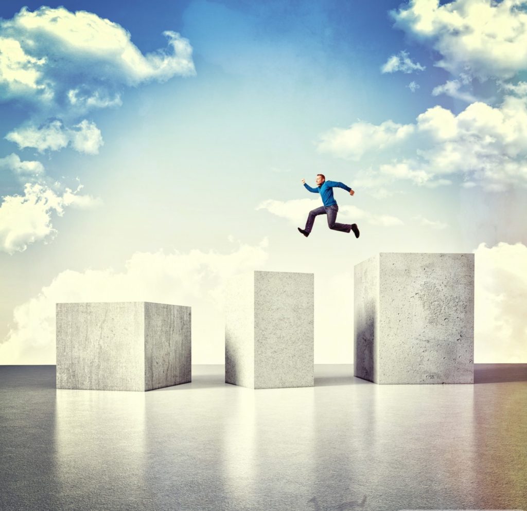 cropped-3d-image-of-huge-concrete-block-and-jumping-man.jpg